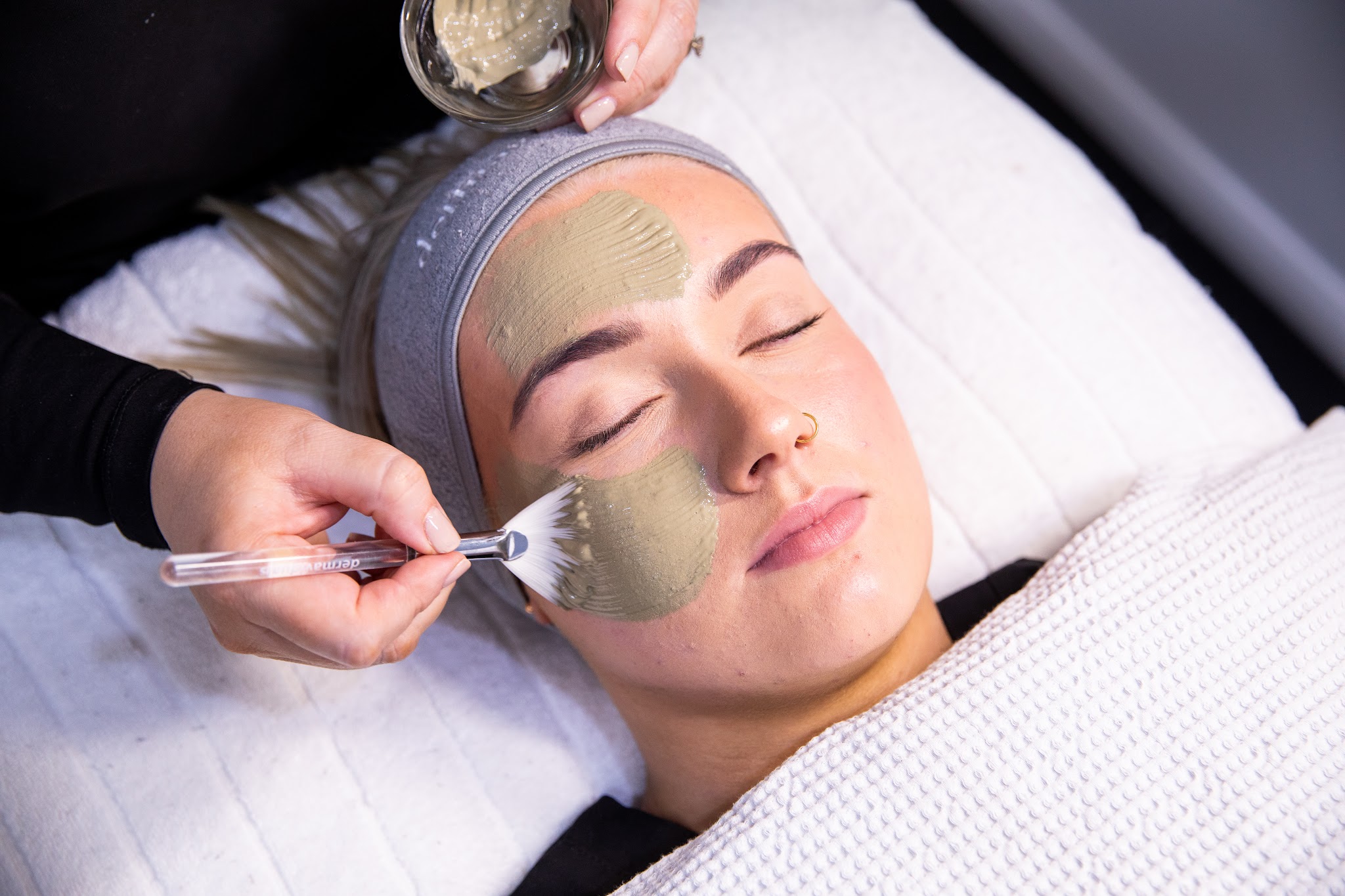 A treatment mask being applied with a dermaviduals brush